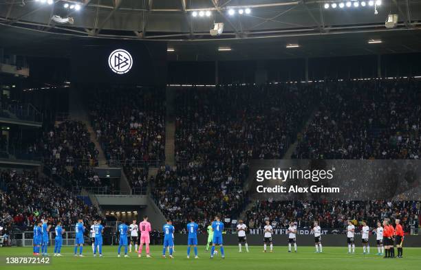 Players, officials and fans take part in a minute of silence prior to the International Friendly match between Germany and Israel at PreZero-Arena on...