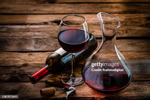 wineglass wine bottle and decanter on rustic wooden table. copy space - wine bottle stock pictures, royalty-free photos & images