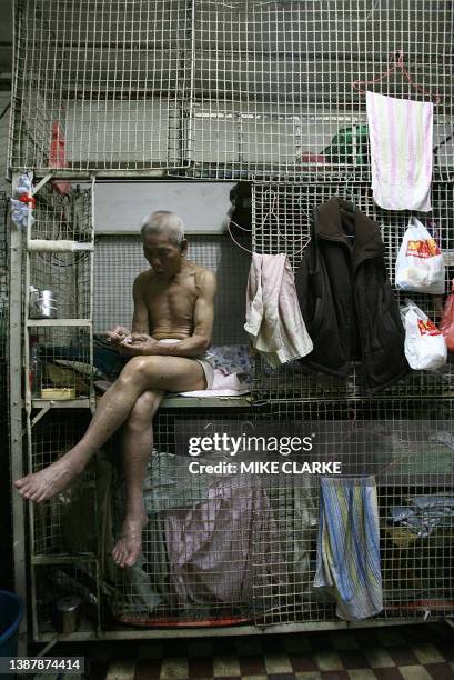 Hongkong-handover-10years-economy This picture taken 14 May, 2007 shows 78-year-old Tai Yum-po sitting on his bed in a "cage dwelling", in one of the...