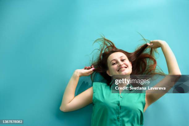 close up portrait of happy redhead young woman with funny face on the blue background. copy space - women open mouth stock pictures, royalty-free photos & images