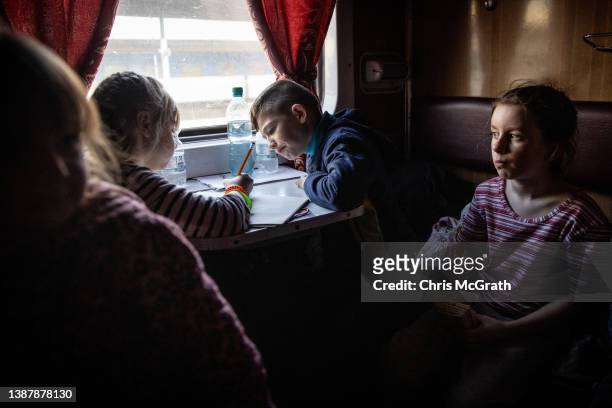 Orphan children get settled on a train after fleeing the town of Polohy which has come under Russian control before evacuating on a train from...