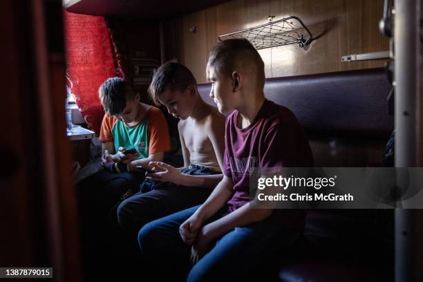 Orphan children get settled on a train after fleeing the town of Polohy which has come under Russian control before evacuating on a train from...