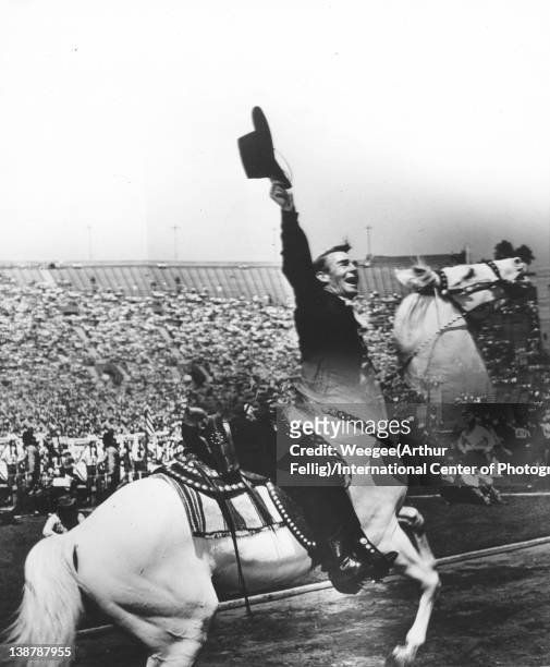 Distortion of American actor Randolph Scott as he rides horse on the field of an outdoor stadium, twentieth century.