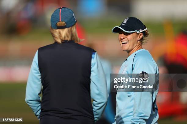 Katherine Brunt of England talks to England head coach Lisa Keightley during the 2022 ICC Women's Cricket World Cup match between England and...