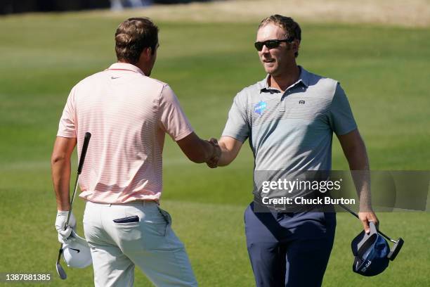 Scottie Scheffler of the United States shakes hands with Seamus Power of Ireland on the 16th hole after defeating him 3&2 in their quarterfinal match...