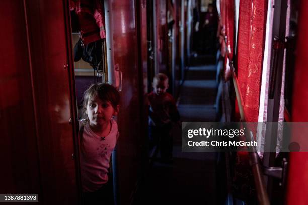 Orphan children get settled on a train after fleeing the town of Polohy which has come under Russian control before evacuating on a train from...