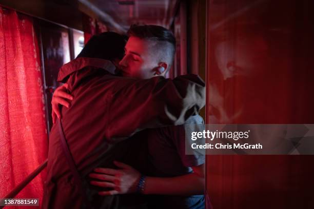 An orphan boy hugs a volunteer goodbye after fleeing the town of Polohy which has come under Russian control before evacuating on a train from...
