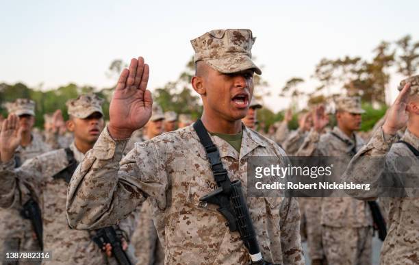 Marine Corps recruits take part in the traditional Eagle, Globe and Anchor medal ceremony March 26, 2022 at the Marine base on Parris Island, South...