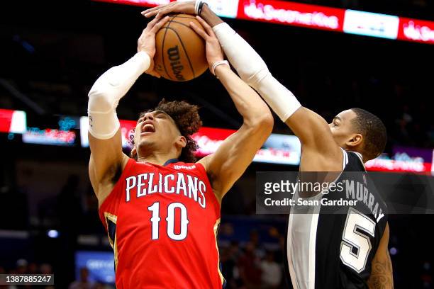 Jaxson Hayes of the New Orleans Pelicans is fouled by Dejounte Murray of the San Antonio Spurs during the first quarter of an NBA game at Smoothie...