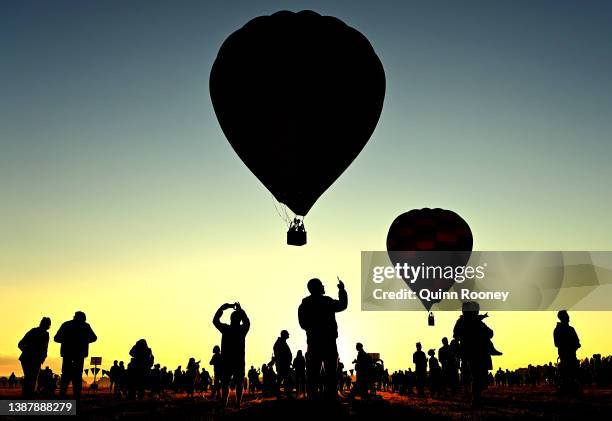 Spectators watch on as Hot Air Balloons take flight from Brown Brothers Milawa Airfield on March 27, 2022 in Wangaratta, Australia. The King Valley...