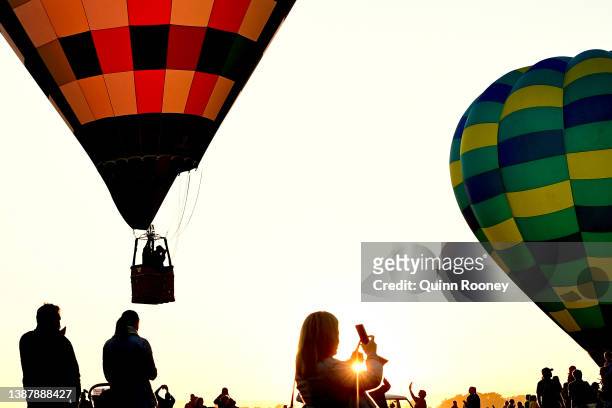 Spectators watch on as Hot Air Balloons take flight from Brown Brothers Milawa Airfield on March 27, 2022 in Wangaratta, Australia. The King Valley...