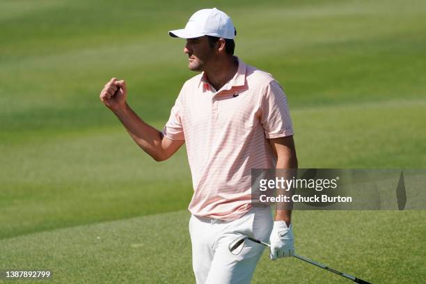 Scottie Scheffler of the United States celebrates after chipping in for eagle on the 16th hole to defeat Seamus Power of Ireland 3&2 in their...
