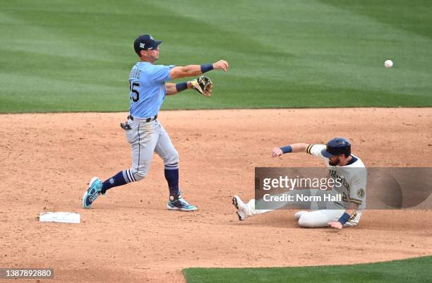 Dylan Moore of the Seattle Mariners turns a double play on a ground ball hit by Kolten Wong of the Milwaukee Brewers as Steven Souza Jr is forced out...
