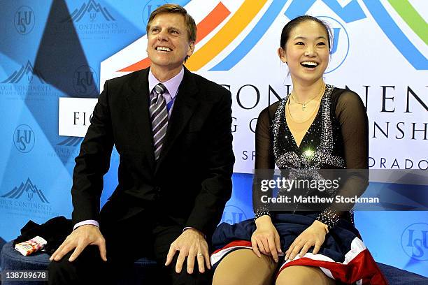 Coach Peter Oppegard and Caroline Zhang wait for her scores in the Kiss & Cry after the Ladies Free Skate during the ISU Four Continents Figure...