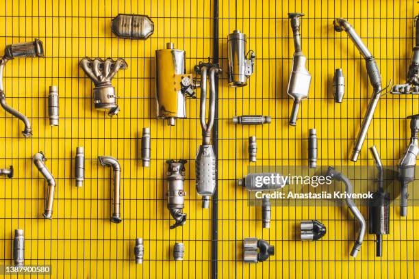 various car parts and accessories on yellow background. - teil eines fahrzeugs stock-fotos und bilder