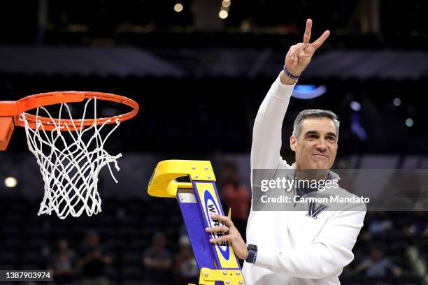 Head coach Jay Wright of the Villanova Wildcats cuts down the net after defeating the Houston Cougars 50-44 in the NCAA Men's Basketball Tournament...