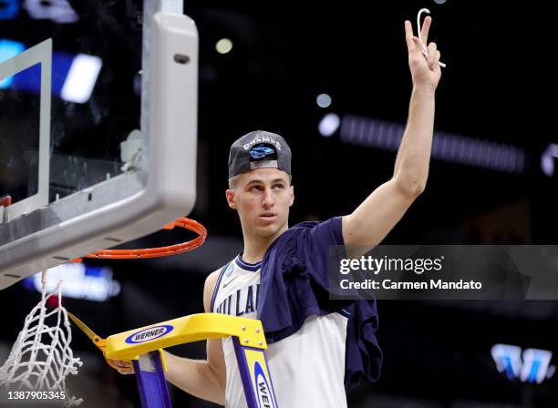 Collin Gillespie of the Villanova Wildcats cuts the net after the Wildcats defeat the Houston Cougars 50-44 in the NCAA Men's Basketball Tournament...