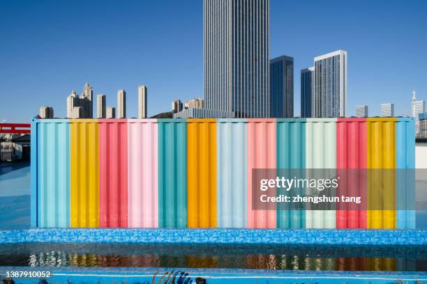 multi colored wall with the background of city skyline. - graffiti wall stockfoto's en -beelden