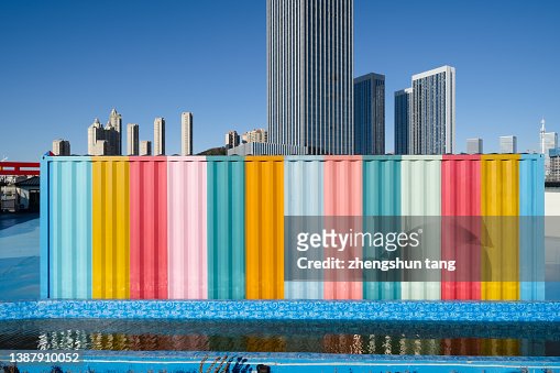 Multi colored wall with the background of city skyline.