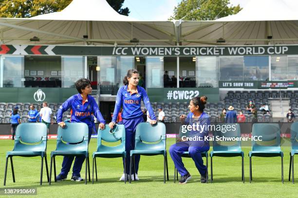 Poonam Yadav, Renuka Singh Thakur and captain Mithali Raj of India speak before posing for a team photo ahead of the 2022 ICC Women's Cricket World...