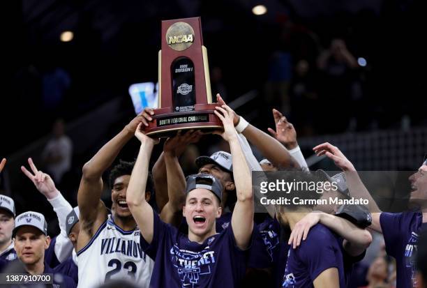 The Villanova Wildcats celebrate with the trophy after defeating the Houston Cougars 50-44 in the NCAA Men's Basketball Tournament Elite 8 Round at...
