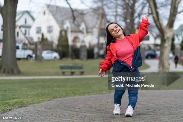 confident latin woman with dwarfism outdoors feeling good - little people stock pictures, royalty-free photos & images