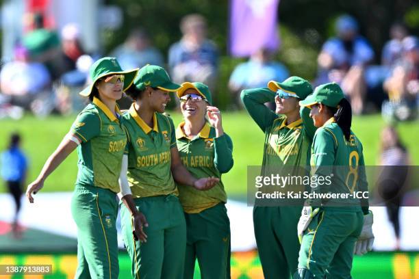 Chloe Tryon of South Africa is congratulated by team mates after dismissing Yastika Bhatia of India during the 2022 ICC Women's Cricket World Cup...