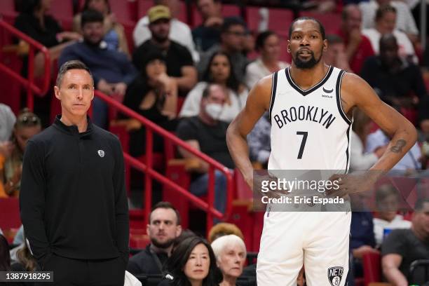 Head Coach Steve Nash and Kevin Durant of the Brooklyn Nets look on during the second half against the Miami Heat at FTX Arena on March 26, 2022 in...