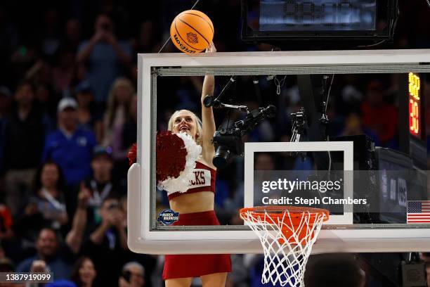 An Arkansas Razorbacks cheerleader is lifted up to get a stuck ball down during the second half against the Duke Blue Devils in the NCAA Men's...