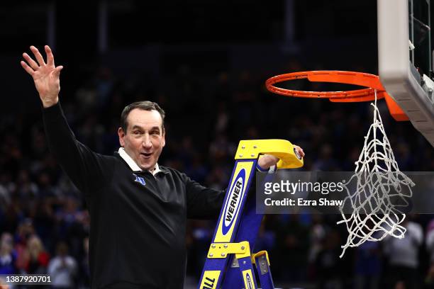 Head coach Mike Krzyzewski of the Duke Blue Devils climbs the ladder to cut down the net after defeating the Arkansas Razorbacks 78-69 during the...