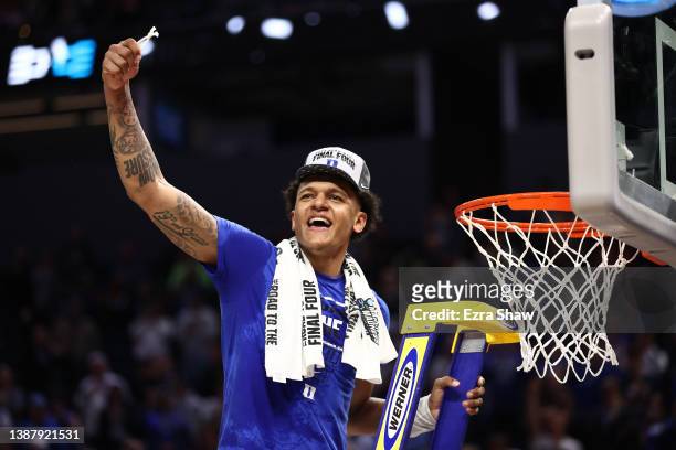 Paolo Banchero of the Duke Blue Devils celebrates after cutting down the net after defeating the Arkansas Razorbacks 78-69 during the second half in...