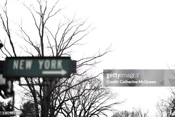 old-fashioned metal street sign: this way to new york city - opportunity sign stock pictures, royalty-free photos & images