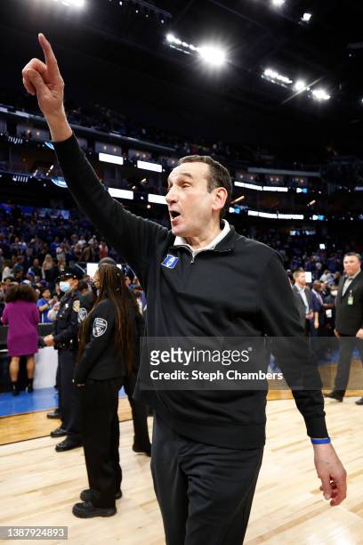 Head coach Mike Krzyzewski of the Duke Blue Devils points to fans as he walks off the court after defeating the Arkansas Razorbacks 78-69 in the NCAA...