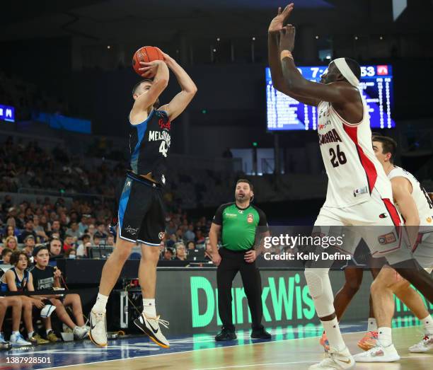 Chris Goulding of United shoots against Duop Reath of the Hawks during the round 17 NBL match between Melbourne United and Illawarra Hawks at John...