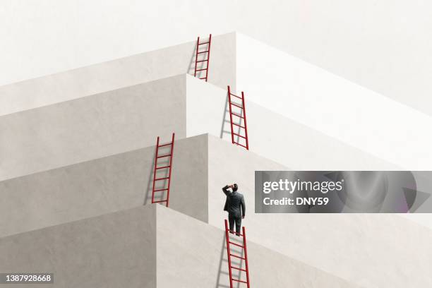 man looks up at series of ladders leading to successively higher levels - carrièreladder stockfoto's en -beelden