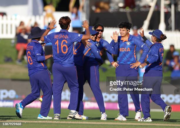 Indian players celebrate the run out of Lizelle Lee from South Africa during the 2022 ICC Women's Cricket World Cup match between India and South...