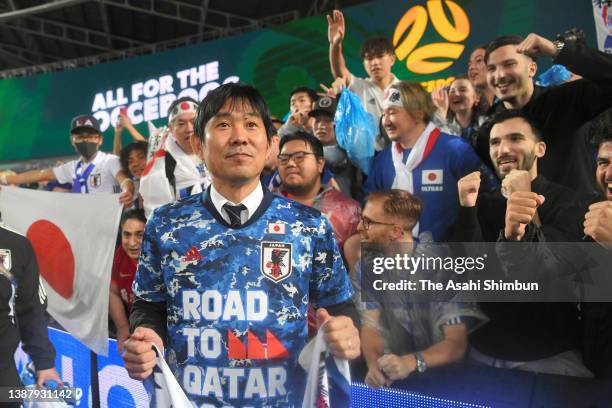 Head coach Hajime Moriyasu of Japan poses with fans after qualified fo the World Cup following his side's 2-0 victory in the FIFA World Cup Asian...