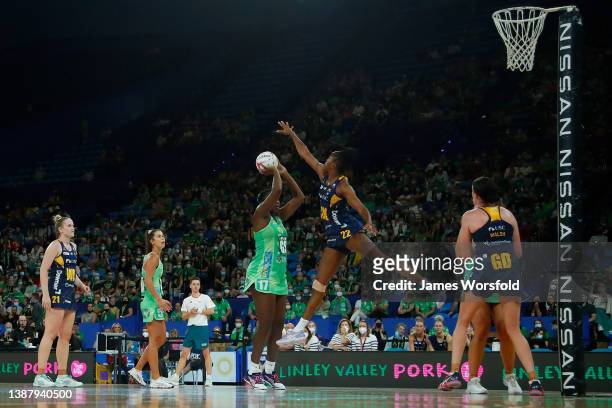 Kadie-Ann Dehaney of the lightning tries to block the shot from Jhaniele Fowler of the fever during the round one Super Netball match between West...
