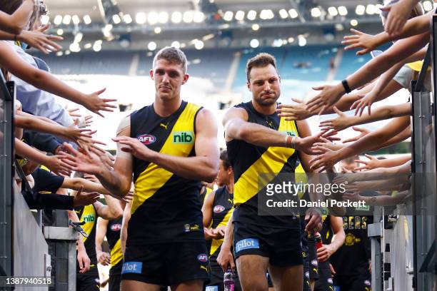 Toby Nankervis of the Tigers and Ben Miller of the Tigers lead the team off the field after winning the round two AFL match between the Richmond...