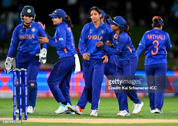 Harmanpreet Kaur of India is congratulated by team mates after dismissing Sune Luus of South Africa during the 2022 ICC Women's Cricket World Cup...