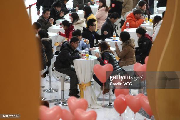 Men and women gather during a 'singles fair' as they look for potential partners at Joy City on February 11, 2012 in Shanghai, China. Preparations...