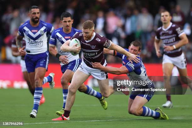 Brad Parker of the Sea Eagles is tackled during the round three NRL match between the Manly Sea Eagles and the Canterbury Bulldogs at 4 Pines Park,...