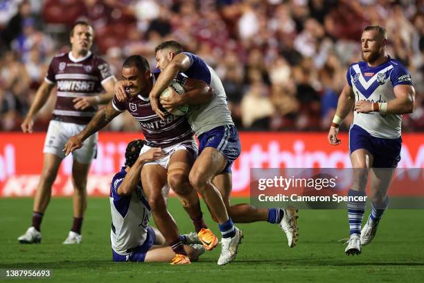 Dylan Walker of the Sea Eagles is tackled during the round three NRL match between the Manly Sea Eagles and the Canterbury Bulldogs at 4 Pines Park,...