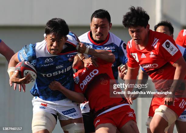 Yoshitaka Tokunaga of Toshiba Brave Lupus Tokyo is tackled during the NTT Japan Rugby League One match between Kobelco Kobe Steelers and Toshiba...