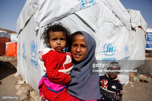 Yemeni internally displaced children, who fled homes escaping conflict, are seen at a displaced persons camp on the outskirts of Sana'a, on March 25,...