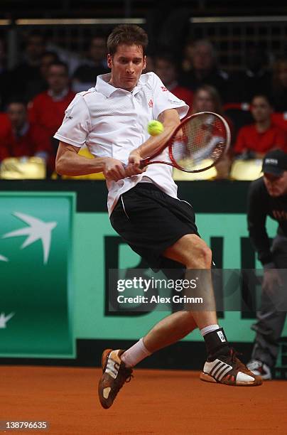 Florian Mayer of Germany returns the ball to Juan Ignacio Chela of Argentina on day 3 of the Davis Cup World Group first round match between Germany...