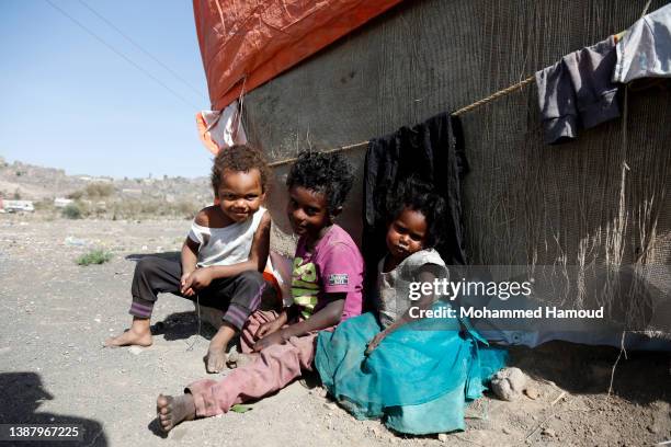 Yemeni internally displaced children, who fled homes escaping conflict, are seen at a displaced persons camp on the outskirts of Sana'a, on March 25,...