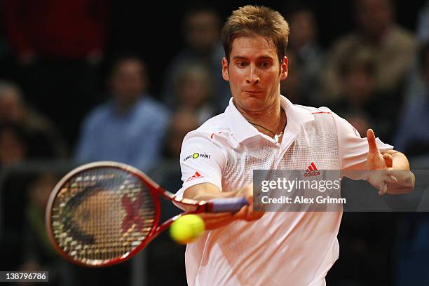 Florian Mayer of Germany returns the ball to Juan Ignacio Chela of Argentina on day 3 of the Davis Cup World Group first round match between Germany...