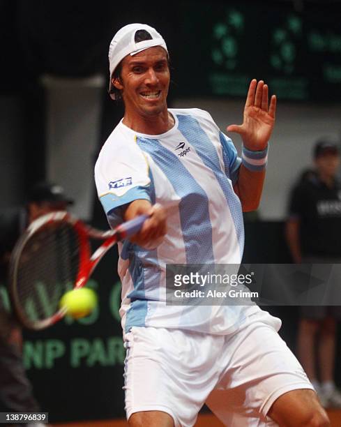 Juan Ignacio Chela of Argentina returns the ball to Florian Mayer of Germany during the Davis Cup World Group first round match between Germany and...