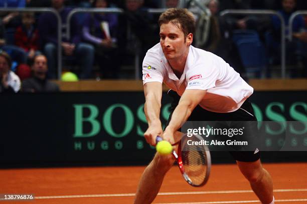 Florian Mayer of Germany returns the ball to Juan Ignacio Chela of Argentina on day 3 of the Davis Cup World Group first round match between Germany...